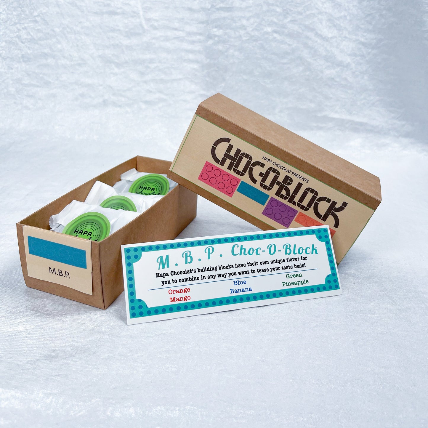 A brown slide box open with 3 packets in side and an information guide.