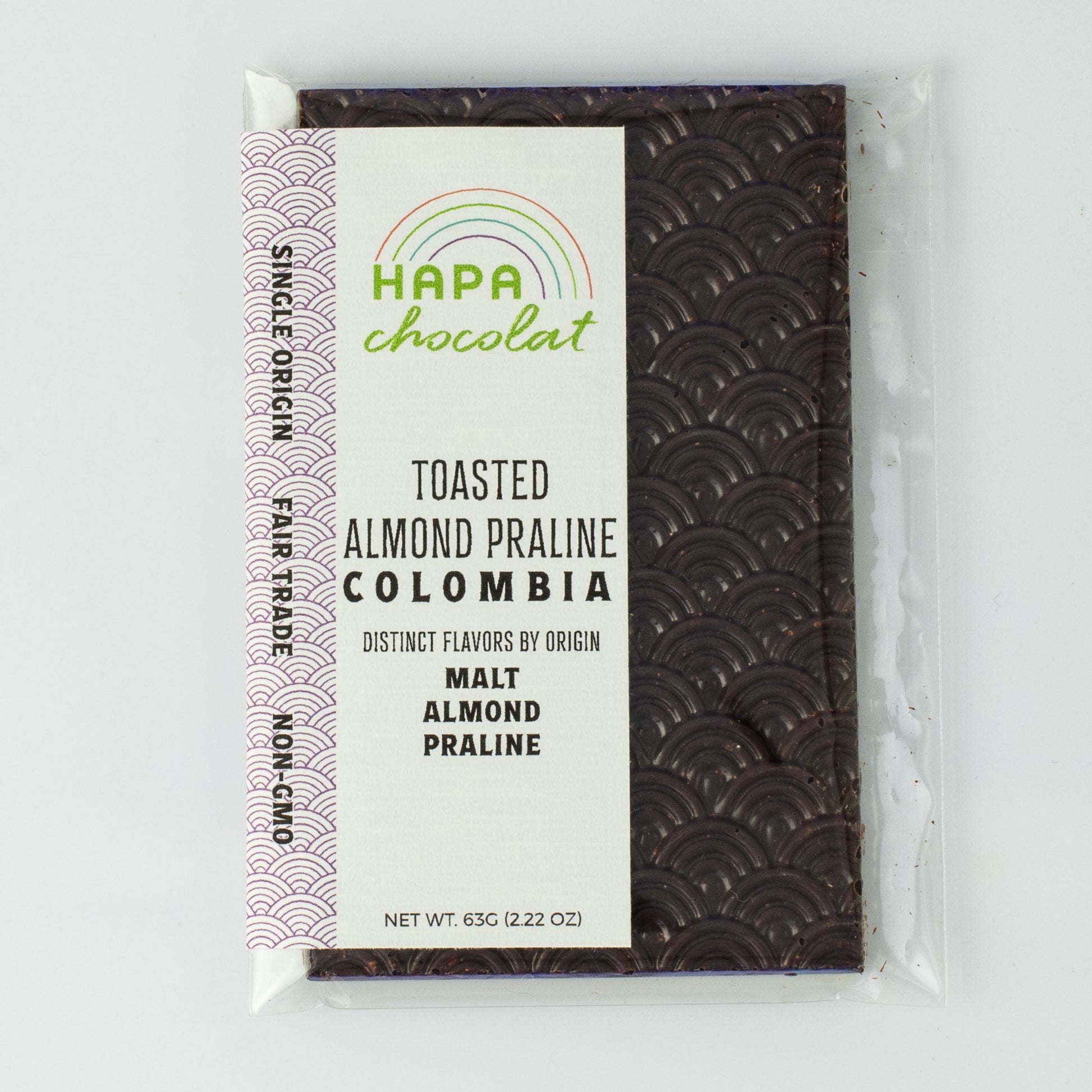 A seigaiha pattern dark chocolate bar in an eco-cello bag with an ivory colored label with the logo and product descriptions.