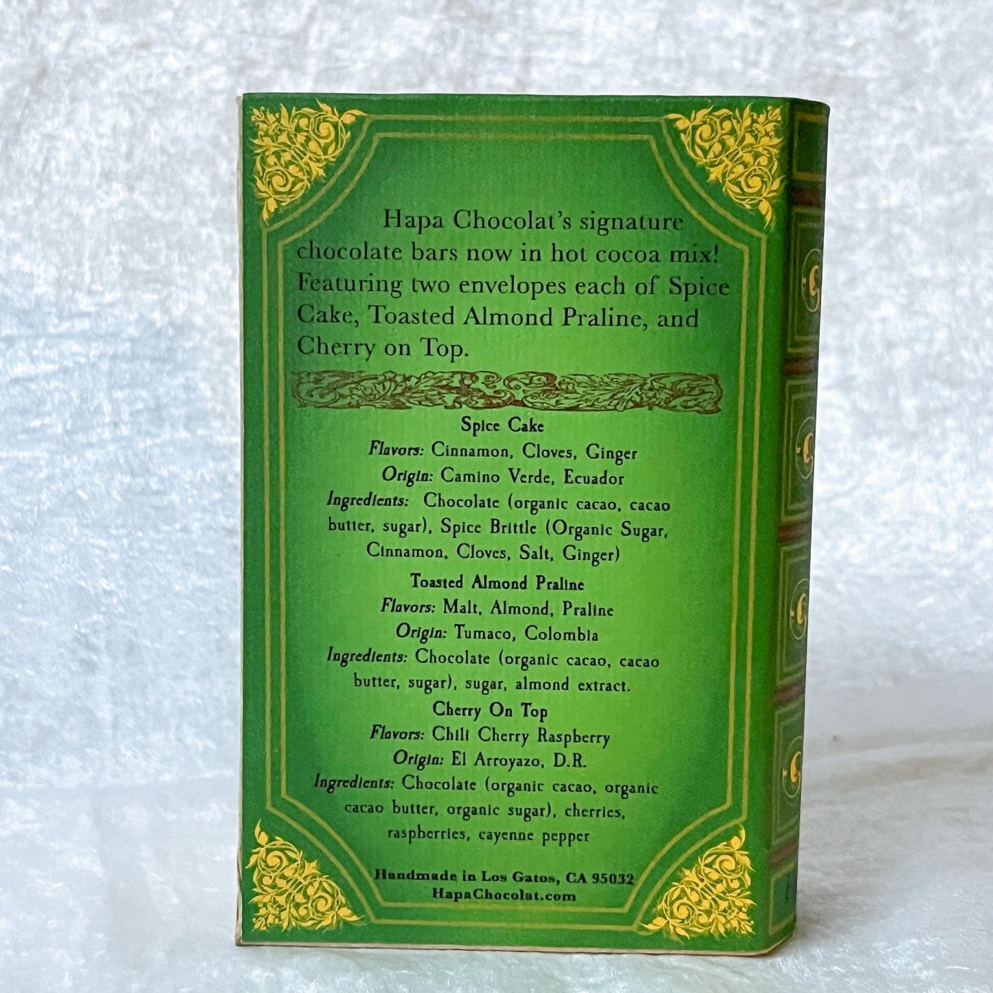 Back cover of a green book with a white background.