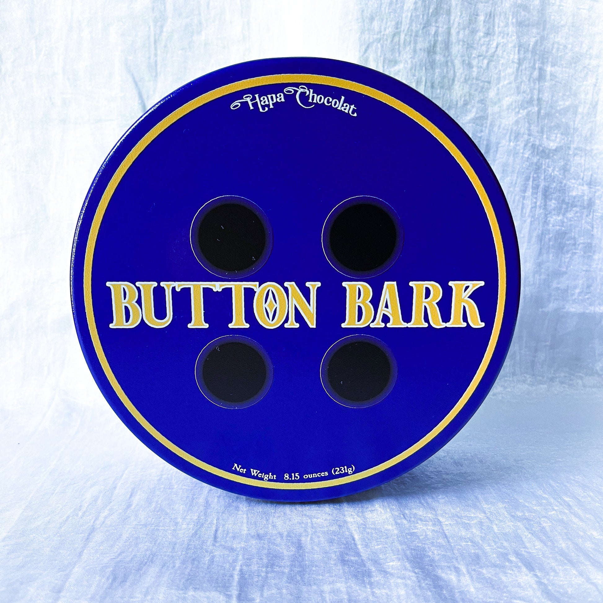A blue tin that looks like a button.
