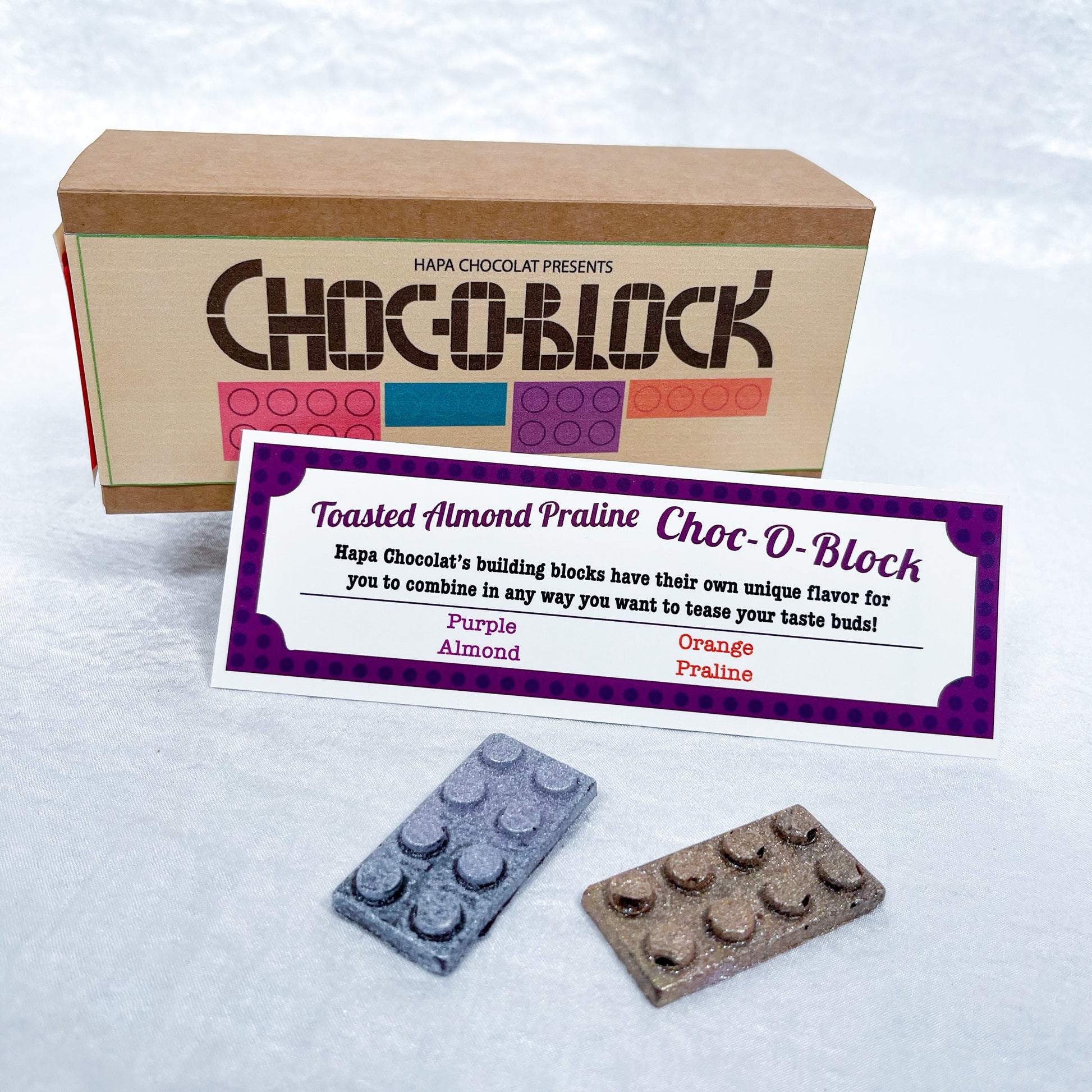 A brown box with an information guide and 2 different colored blocks.