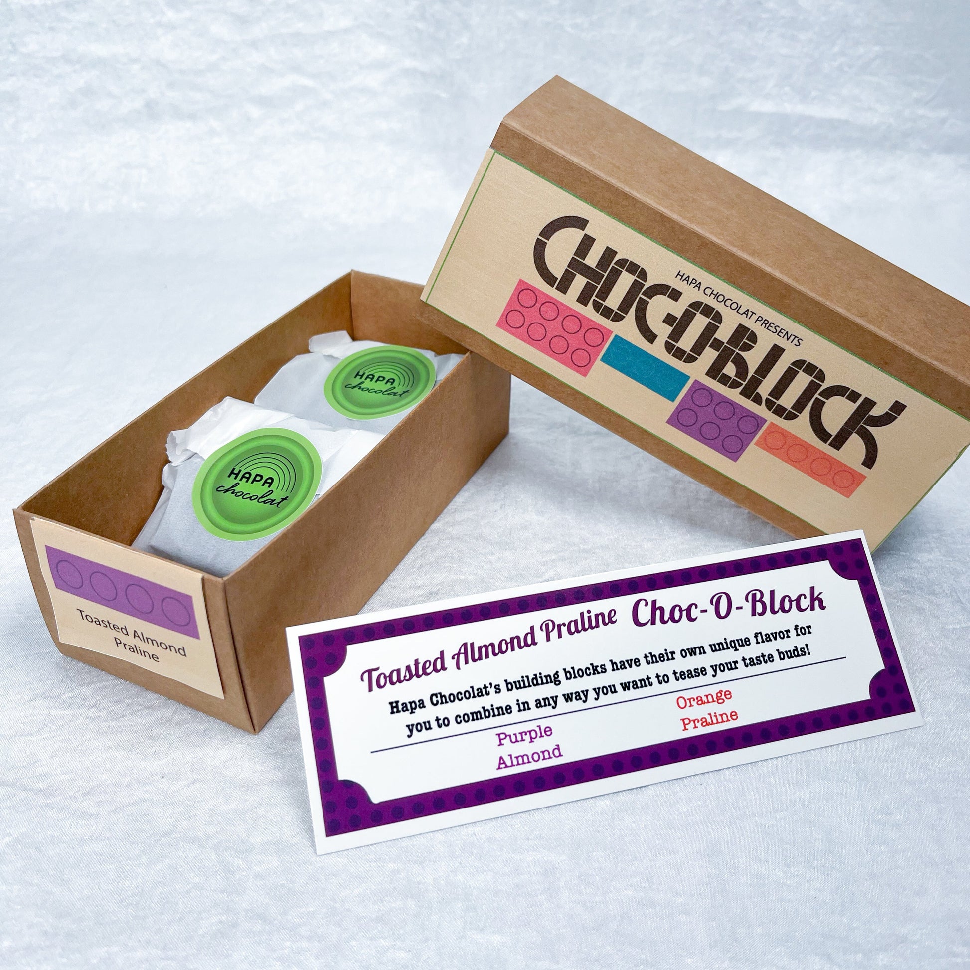 A brown slide box open with 2 packets in side and an information guide.