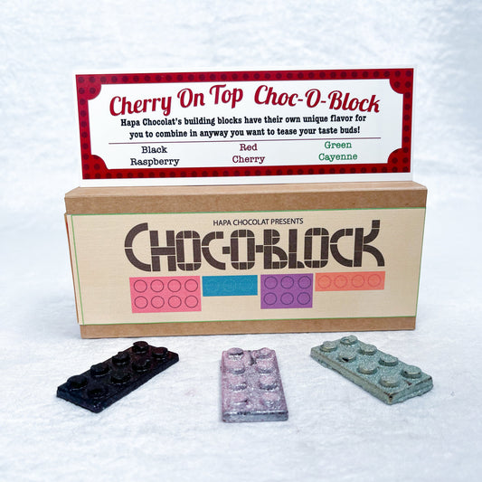 Brown box with an information guide on top and 3 different colored blocks.