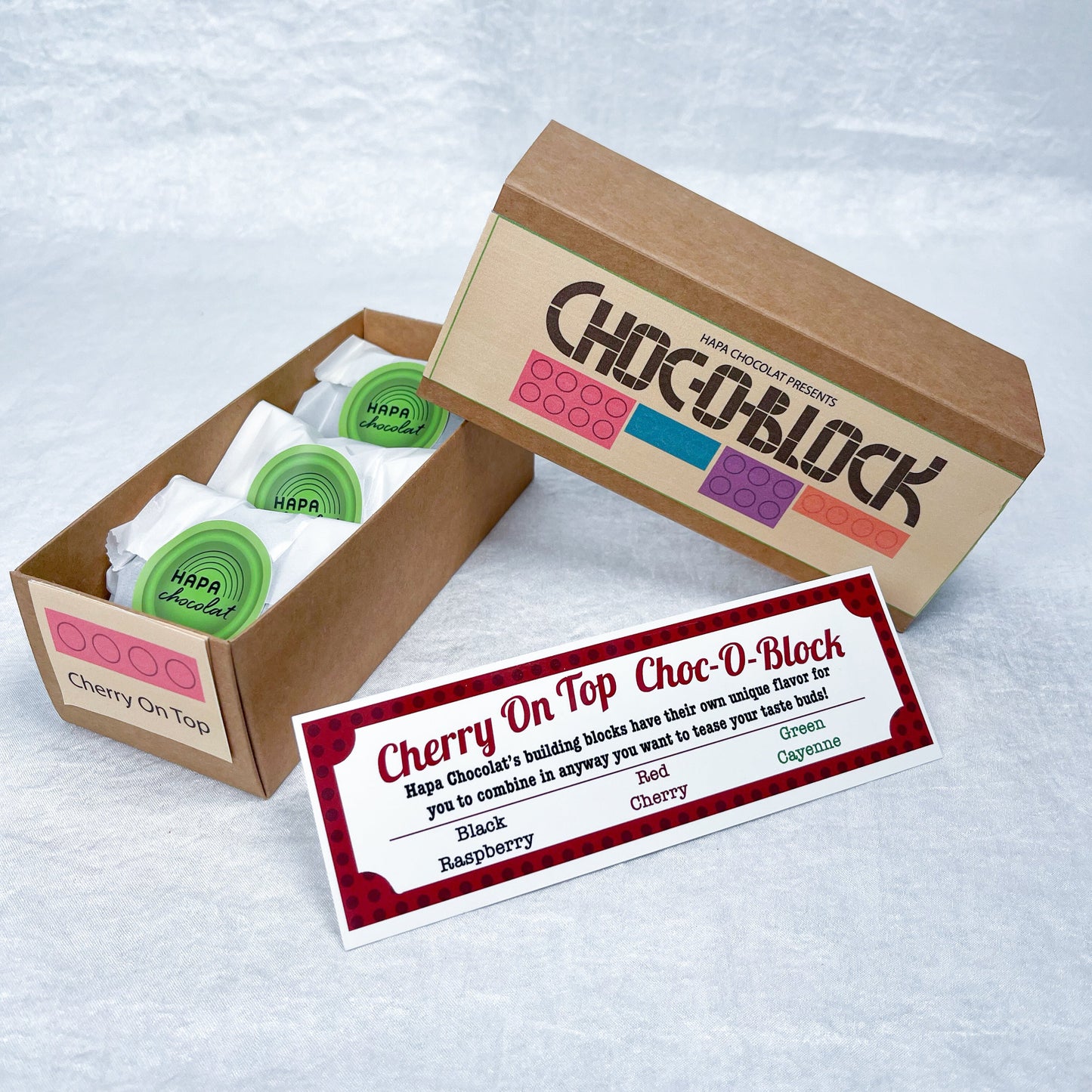 A brown slide box open with 3 packets in side and an information guide.