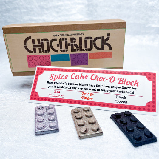 A brown box with an information guide and 3 different colored bricks