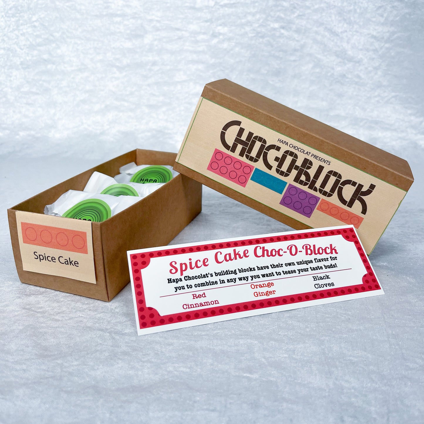 A brown slide box open with 3 packets in side and an information guide.